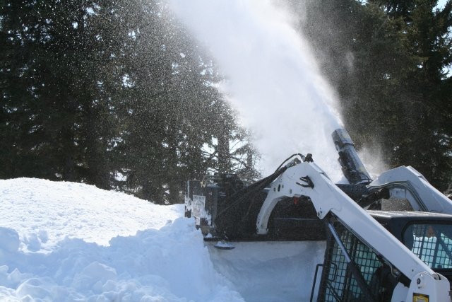 Hydramax Snow Blower blowing while lifted up.